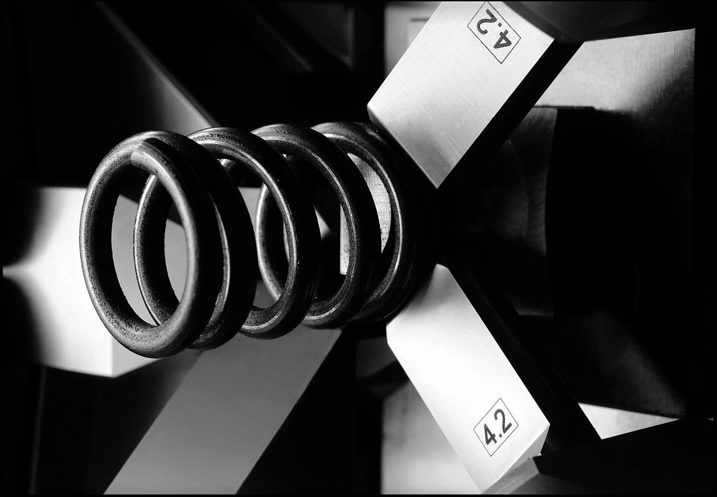 Finished spring held between Simplex-Rapid coiling tools